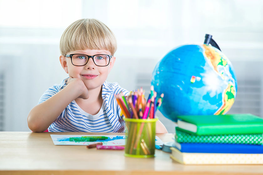 Cute little boy study. Child with books and globe learning