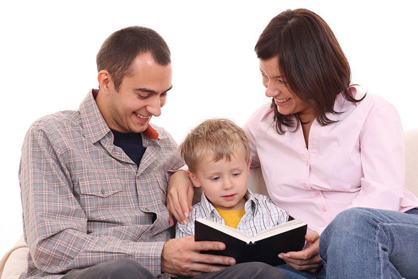 Father mother and 3-4 years old kid reading book