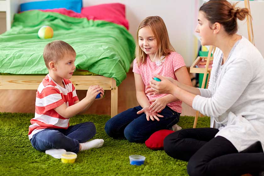 Kids and mother with modelling clay or slimes