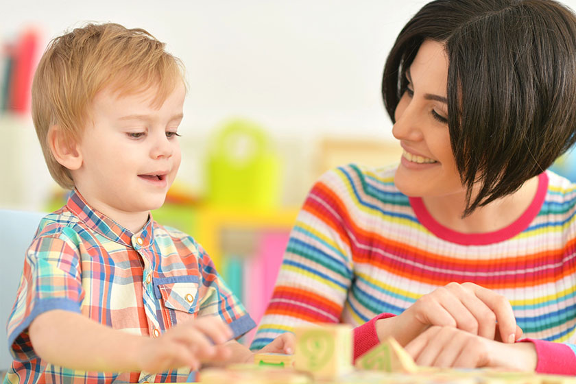 Young mother playing with son